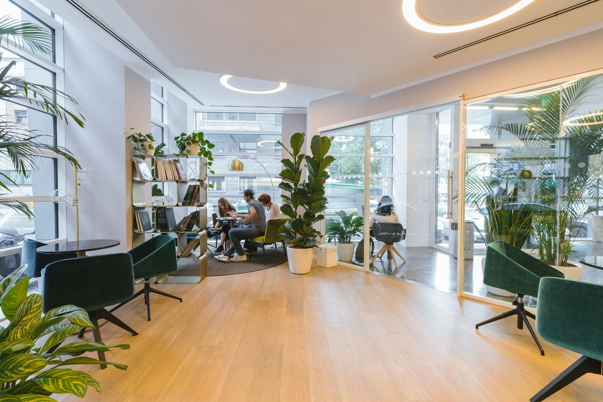Helles, modernes Büro mit Grünpflanzen und Teamgesprächen im Hintergrund